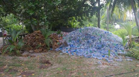 Photo of coconut shells and plastic bottles